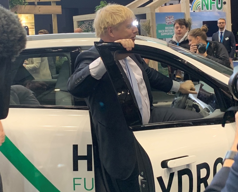 PM Boris Johnson climbs behind the wheel of a hydrogen car from Pebley Beach
